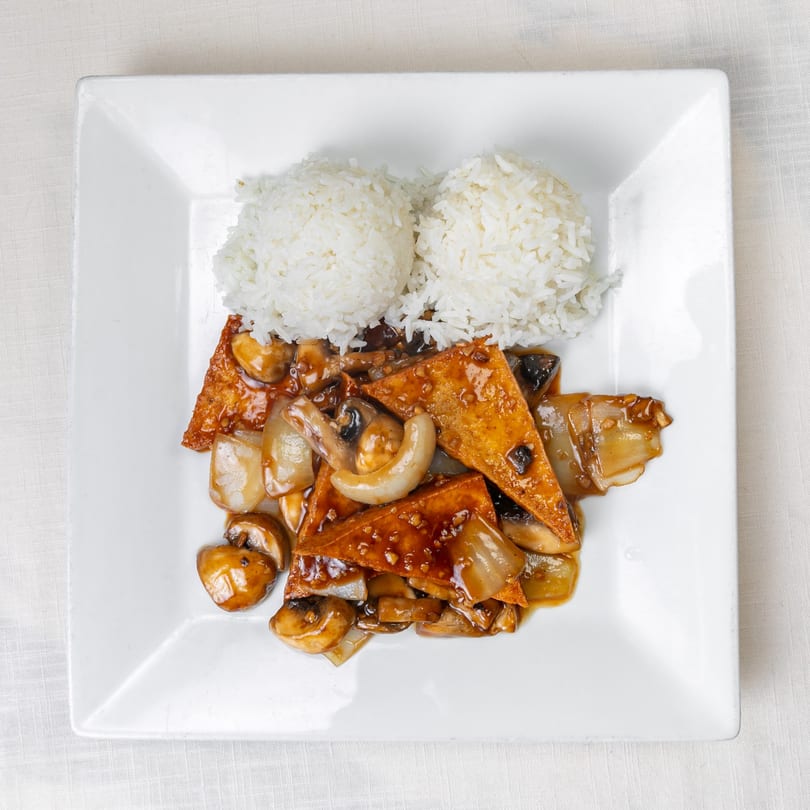 Flaming Wok's fried tofu with mushrooms and onions in brown sauce, served with white rice.